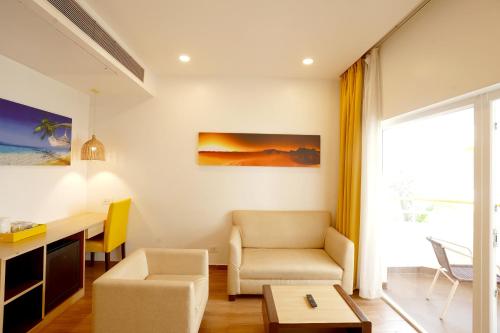 a living room with a desk and a chair at BloomSuites l Calangute in Calangute