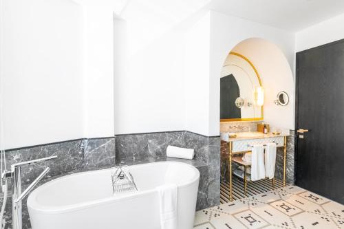 a bathroom with a tub and a sink at Fairmont La Marina Rabat Sale Hotel in Rabat