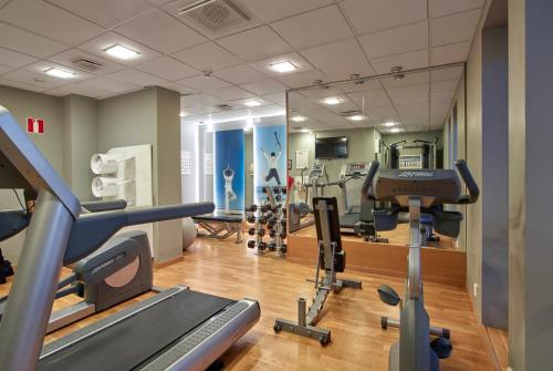 a gym with treadmills and machines in a room at Scandic Grand Hotel in Örebro