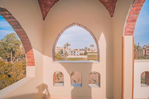 an arched window in a room with a view at Tasneem Palace in Luxor