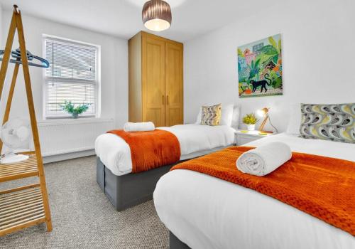 a bedroom with two beds and a ladder at Station Walk By My Getaways in Brighton & Hove