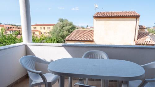 a blue table and chairs on a balcony at residence lu soli budoni affitti in Budoni