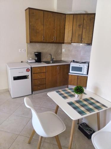 una cucina con tavolo bianco e frigorifero bianco di New cozy sd No1 in Tzafi Apartments a Mesongi