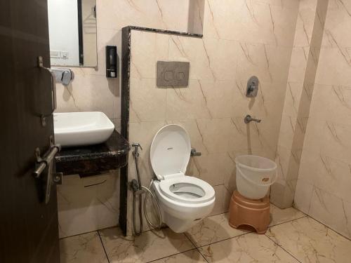a bathroom with a toilet and a sink at THE Flight path Unit By Urban Luxury Delhi Airport in New Delhi
