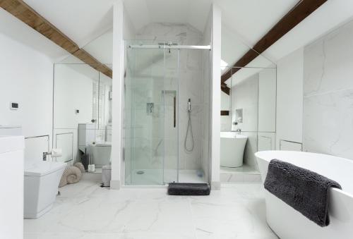 a bathroom with a shower and a toilet and a sink at The Timber Barn in Downton