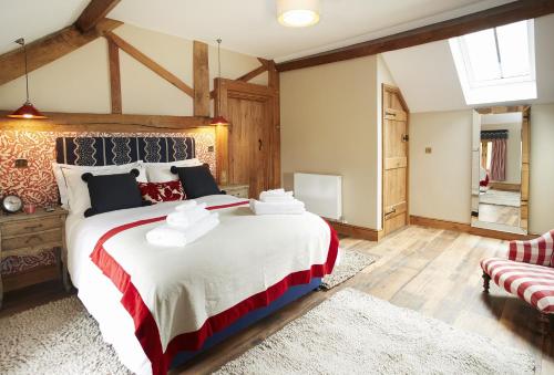 A bed or beds in a room at The Stone Barn