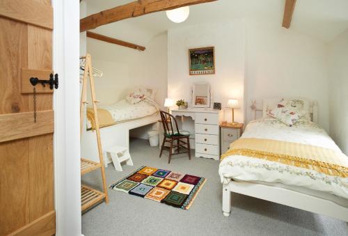 a bedroom with a bed and a desk and a desk at Troedrhiwfawr in Aberystwyth