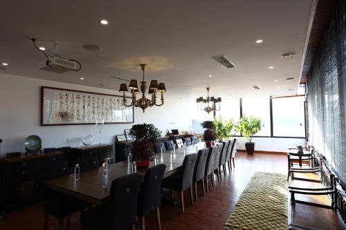 a dining room with a long table and chairs at Hotel Cote Cour Deductive Beijing - Quadrangle close to Tiananmen Square & Forbidden City & Nanluoguxiang, Walk to Wangfujing, English speaking, Free WiFi, Free Laundry, Free Wonton & Noodles with Tour ticket service, Free selfies with ancient costume in Beijing
