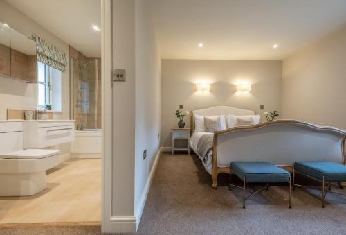 a bedroom with a bed and a bathroom at Stables Cottage in Tilton