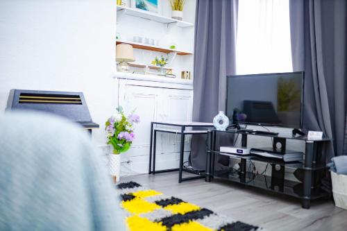 a living room with a table and a tv at Beautiful 2 Bedroom House - Free Parking - LT House in Leicester