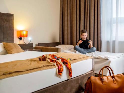 Rúm í herbergi á Hotel Mercure Graz City