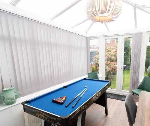 a pool table in a living room with a ceiling at Ideal Lodgings In Audenshaw in Manchester