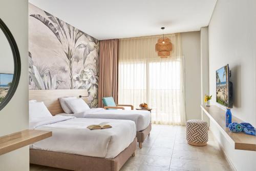 Ένα ή περισσότερα κρεβάτια σε δωμάτιο στο Three Corners Sunny Beach Resort