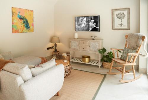 a living room with a couch and a chair at Woodland Retreat in Burton upon Trent