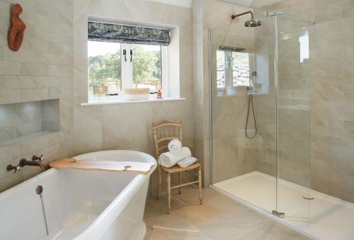 a bathroom with a bath tub and a shower at Woodland Retreat in Burton upon Trent
