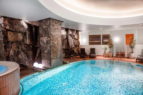 a pool in a hotel room with a rock wall at Radisson Blu Royal Viking Hotel, Stockholm in Stockholm