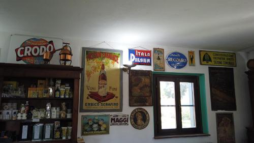 a room with posters on the wall and a window at Locanda le Mandriane in Orbetello