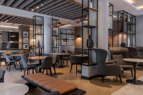 a restaurant with tables and chairs in a room at Park Inn by Radisson, Lagos Victoria Island in Lagos