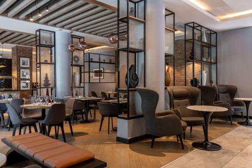 a restaurant with tables and chairs in a room at Park Inn by Radisson, Lagos Victoria Island in Lagos