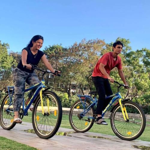 a man and woman riding bikes on a path at Radisson Blu Hotel & Spa, Nashik in Nashik