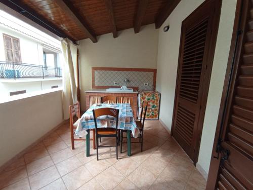 a kitchen with a table and chairs in a room at Sandro Apartment in Castellammare del Golfo