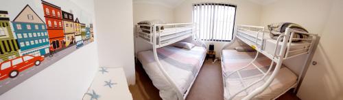 two bunk beds in a small room with at Seashells Bayside Retreat in Busselton