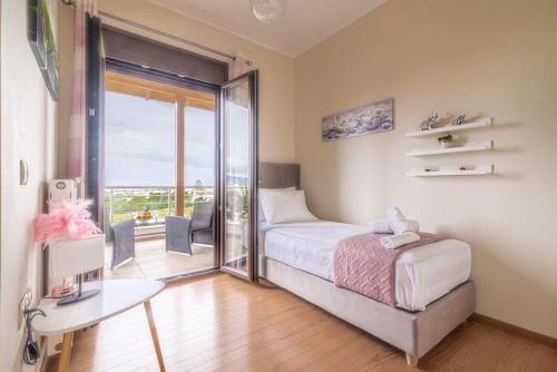 sypialnia z łóżkiem i oknem z balkonem w obiekcie Luxury Maisonette near the Beach w mieście Gázion