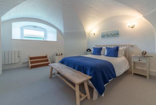 a bedroom with a bed and a bench in it at The Link in Cromer