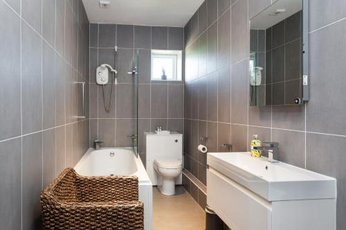 ein Badezimmer mit einem WC, einem Waschbecken und einer Badewanne in der Unterkunft Veronica Cottage in Swanage