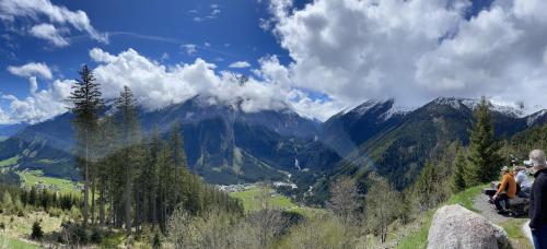 two people sitting on a mountain overlooking a valley at Haus Grübl in Wald im Pinzgau