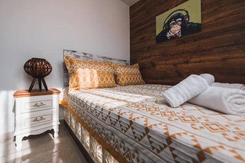 1 cama con cabecero de madera junto a una mesita de noche en Zikas Family's House, en Leptokarya
