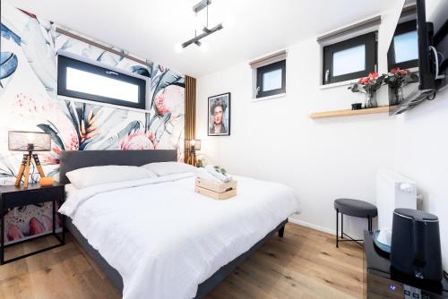 a bedroom with a bed and a tv at Penzion Mácha in Litoměřice