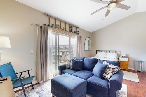 a living room with a blue couch and a bed at Bethany Beach Inn - 39634 Jefferson Bridge Rd #201 in Bethany Beach