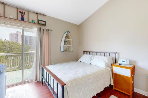 a bedroom with a bed and a large window at Bethany Beach Inn - 39634 Jefferson Bridge Rd #201 in Bethany Beach