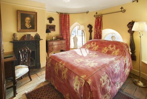 a bedroom with a bed and a desk in it at Toll House in Nether Stowey