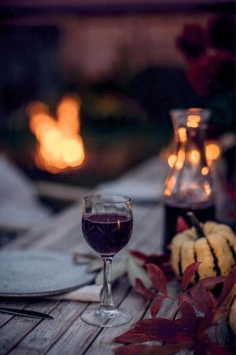 a glass of wine sitting on top of a table at Tokajer Wellness Panzió in Keszthely