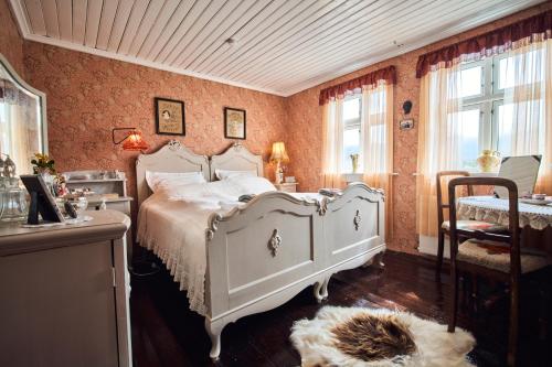 a bedroom with a white bed in a room at Heima í Stovu in Hvalba