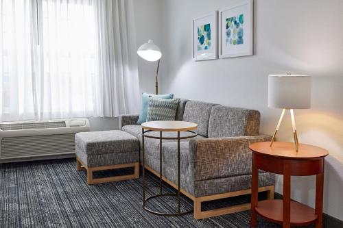 a living room with a couch and a table at TownePlace Suites Medford in Medford