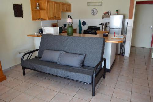 a couch with two pillows on it in a kitchen at Holiday Flat Stormvoel 547 in Hazyview