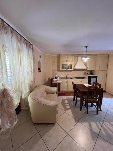 a living room with a white couch and a table at B&B Casa Magaldi in Corleto Perticara