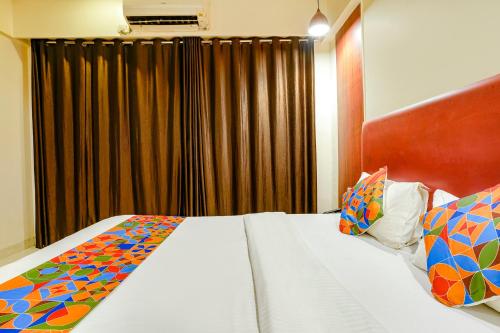 a hotel room with a bed with a curtain at Hotel D69 Residency in Mire