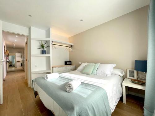 1 dormitorio con 1 cama grande y toallas. en Precioso ático cerca de la playa y Port Aventura, en Salou