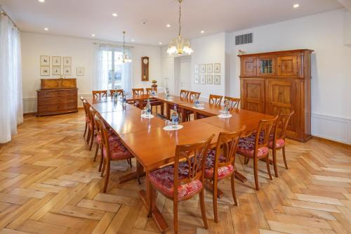 a large dining room with a large wooden table and chairs at Hotel Landgasthof Schönbühl in Schönbühl