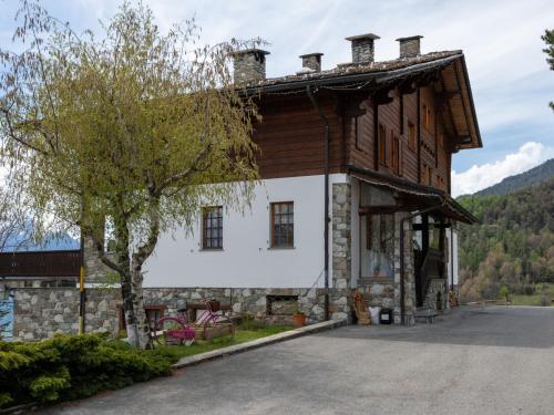 a large wooden house with a tree in front of it at Apartment Hérisson by Interhome in Sarre