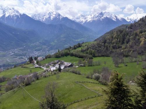 a green field with mountains in the background at Apartment Hérisson by Interhome in Sarre