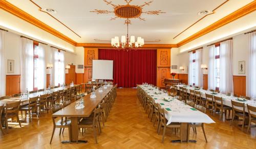 a large room with long tables and chairs at Hotel Landgasthof Schönbühl in Schönbühl