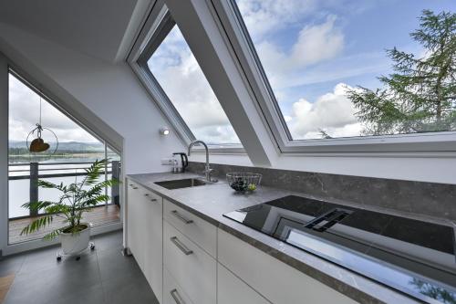 a kitchen with a large window and a sink at Ferienwohnung Carpe Diem in Füssen