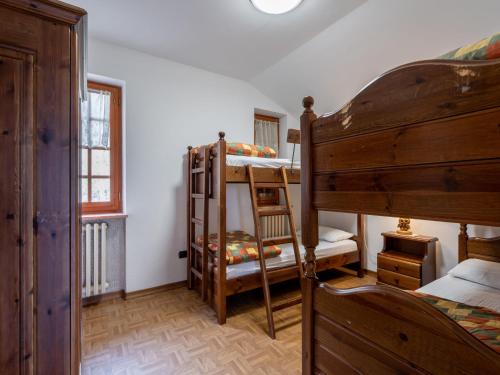 a bedroom with two bunk beds and a window at Apartment Chaouette by Interhome in Sarre