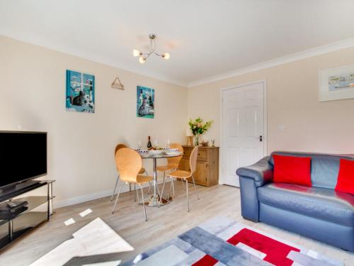 a living room with a couch and a table at Holiday Home Lilac by Interhome in Padstow