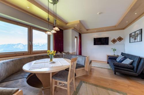 a living room with a table and a couch at Ferienpension Steiner in Weerberg